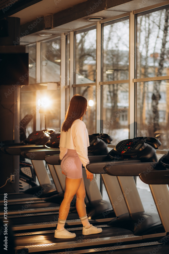 Young woman running on treadmill Young woman running on treadmill
