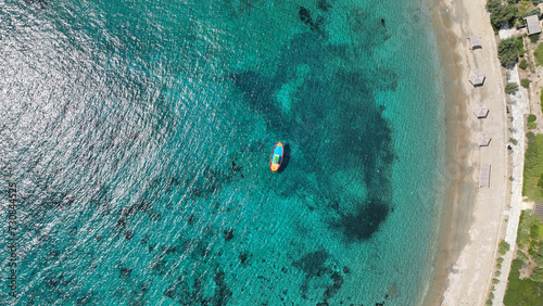 Aerial drone photo of paradise secluded beach and bay of Agios Vasileios located in long peninsula of small island of Schoinousa, Small Cyclades, Greece photo