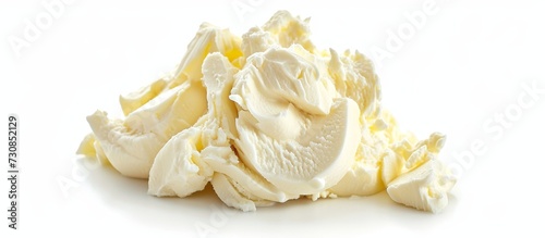 A dollop of whipped cream sitting on a pristine white surface, adding a creamy touch to a delicious dessert.