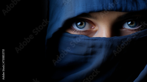 A woman's face half-covered by a shadow, with one blue eye visible showing resilience, against a dark background, suggesting themes of hope and strength.