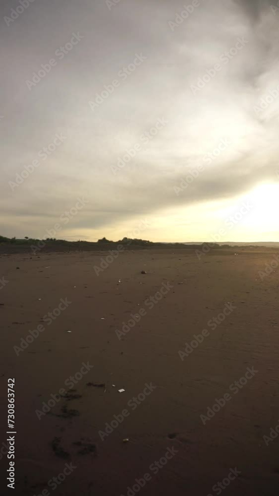 beautiful vertical video view of the sunrise on the beach with small waves, morning natural panorama on Karang Paranje beach, Garut beautiful vertical video view of the sunrise on the beach with small waves, morning natural panorama on Karang Paranje beach, Garut