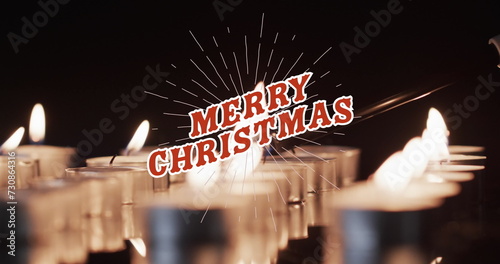 Image of merry christmas text over lit tea candles background