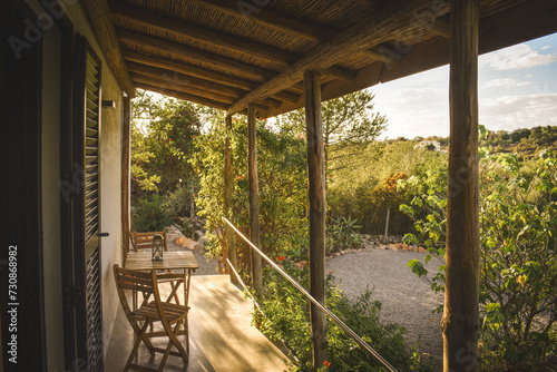 Charming outdoor veranda with stylish furniture set amidst lush trees and shrubs in Portugal