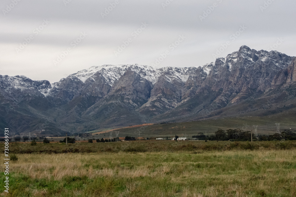 Snow-capped peaks of Breede Valley's distant mountains on a chilly day in Worcester, South Africa