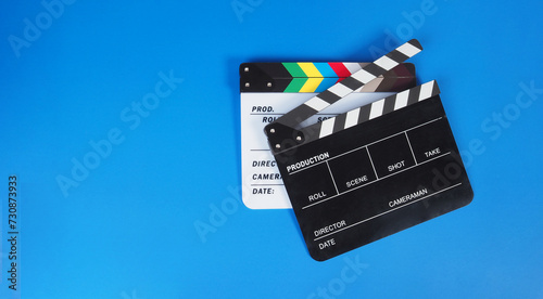 Two Clapper board or movie slate on blue background.. photo