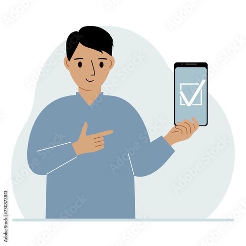 A man is holding a phone with a check mark on the screen. The concept of choice, voting or defence.