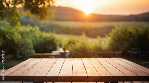 Empty wooden table with blurred summer background with sunset
