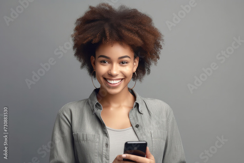 Smiling black woman with smartphone