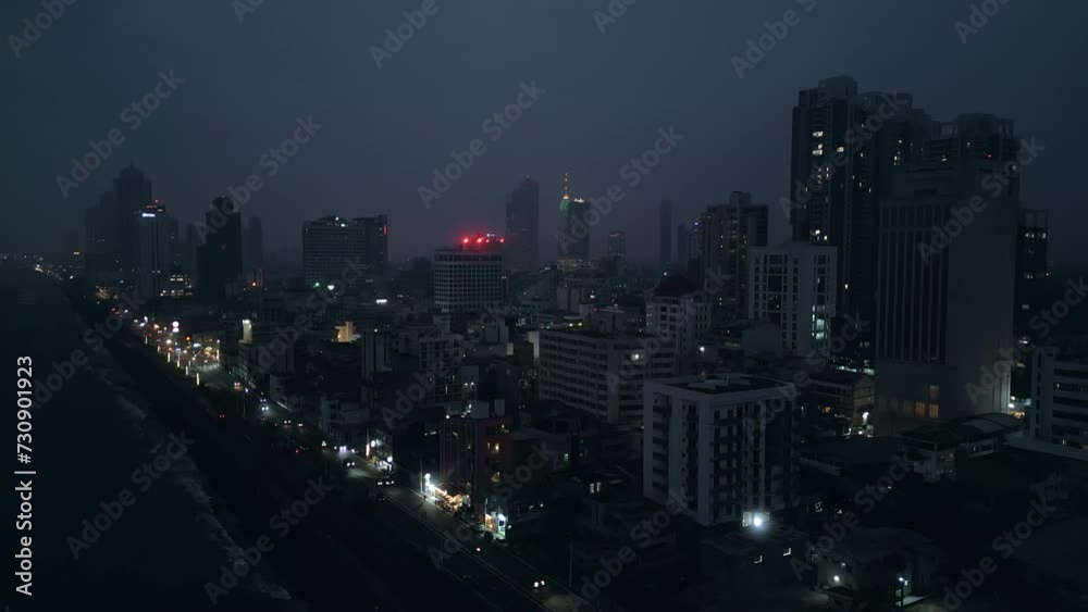 Aerial night view of Colombo cityscape, illuminated streets, high-rises, coastline visible. Urban skyline of Sri Lanka capital, buildings, city lights glimmer. Ideal for travel, urban planning. Aerial night view of Colombo cityscape, illuminated streets, high-rises, coastline visible. Urban skyline of Sri Lanka capital, buildings, city lights glimmer. Ideal for travel, urban planning.