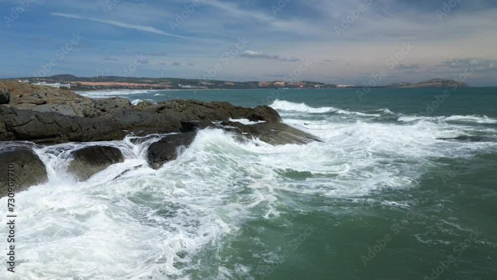 Aerial slow motion view of waves breaking against rocks on a rocky coastline, Large Ocean Beautiful Wave, Awesome power of waves breaking over dangerous rocks. sea waves. Vietnam, Asia coast view. 4K Aerial slow motion view of waves breaking against rocks on a rocky coastline, Large Ocean Beautiful Wave, Awesome power of waves breaking over dangerous rocks. sea waves. Vietnam, Asia coast view. 4K