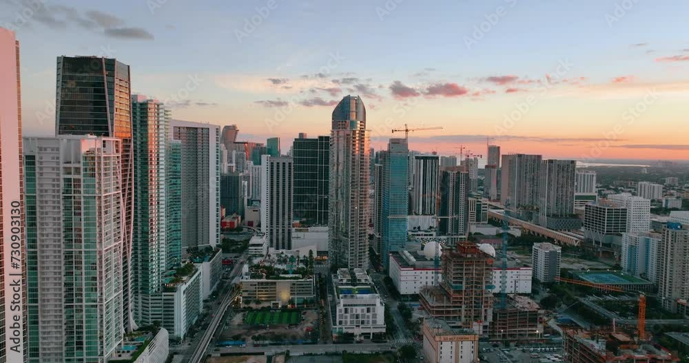 Aerial view evening city with skyscrapers and urban buildings against clear sky. Cityscape of Miami, Florida. Bright sunset with reflection in windows of houses. Aerial view evening city with skyscrapers and urban buildings against clear sky. Cityscape of Miami, Florida. Bright sunset with reflection in windows of houses.