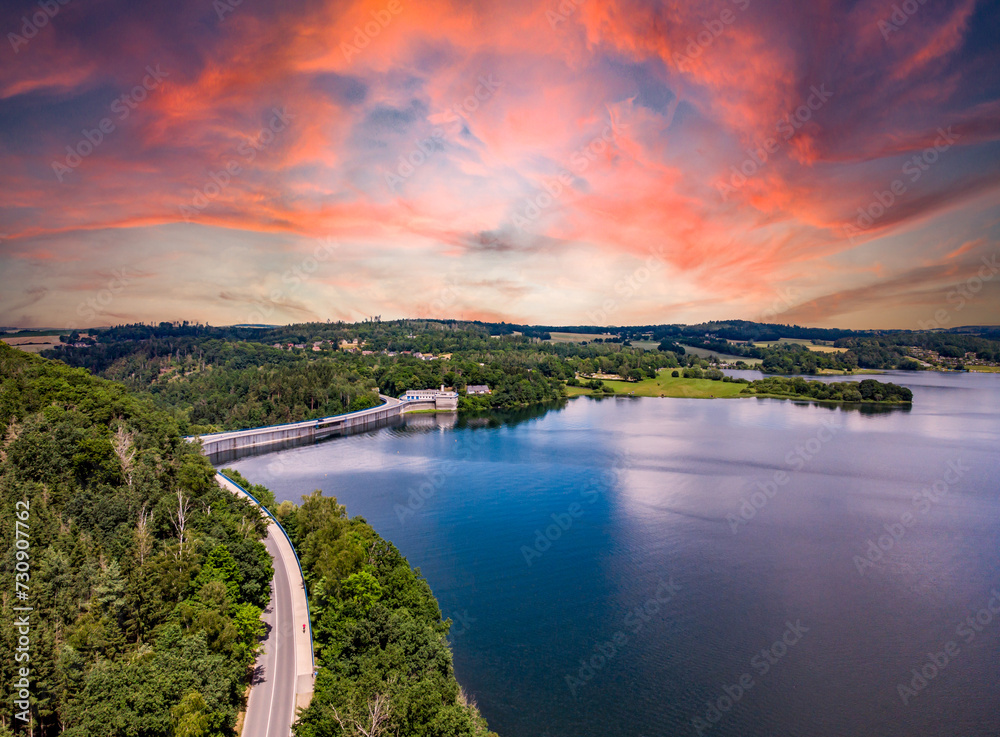 sunset over the poehl lake, vogtland east germany with dam