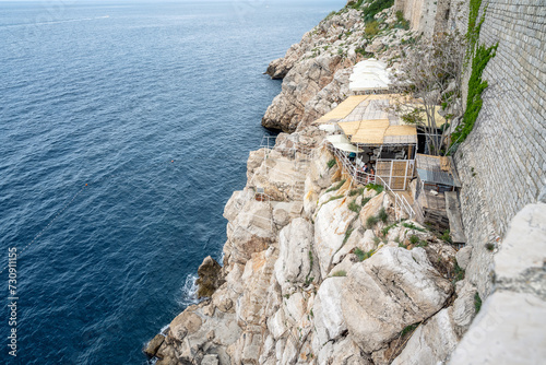 One of the romantic cafes outside the city walls of Dubrovnik, where you can enjoy a beautiful view of high cliffs and endless blue sea.
