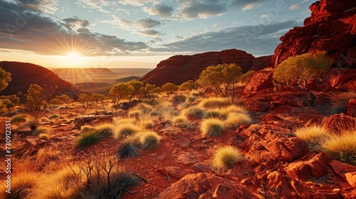 Ancient desert landscape at sunset showcasing red rock formations and sparse vegetation