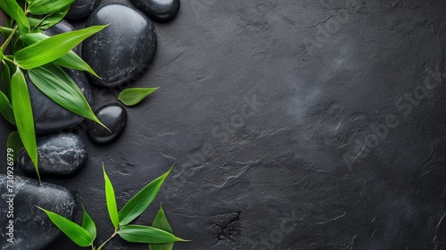 Black spa background  spa concept  green bamboo and black stones