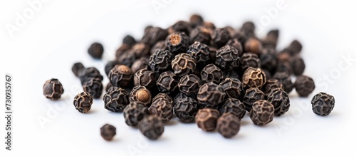 A pile of black pepper on a white background, a popular spice used in cuisine, sourced from plants and known for its distinct flavor