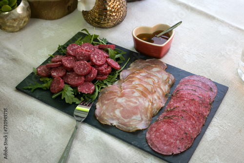 Delicious assortment of Portuguese cured meats, expertly sliced and ready to spice up your visual project. A burst of authentic flavors captured in every frame. photo
