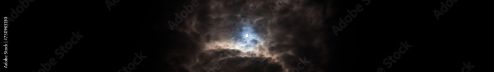 moon glowing through the clouds at night with a strong thunderstorm front during rain moon glowing through the clouds at night with a strong thunderstorm front during rain