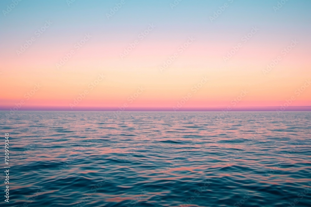 Soft pastel sunset, blending hues, over calm ocean horizon