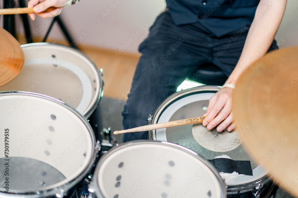 Fototapeta premium close-up musician during rehearsal plays drums musical instrument drumsticks music concert