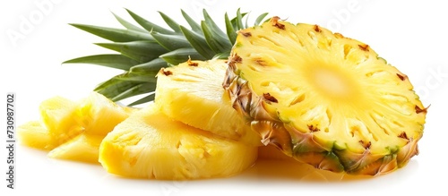 A pineapple, a fruit often used as an ingredient in various cuisines, is cut in half and sliced. It is displayed on a white background.