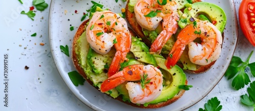 A delicious seafood dish made with shrimp, avocado toast, and a white plate. Get the recipe and start cooking this amazing cuisine!