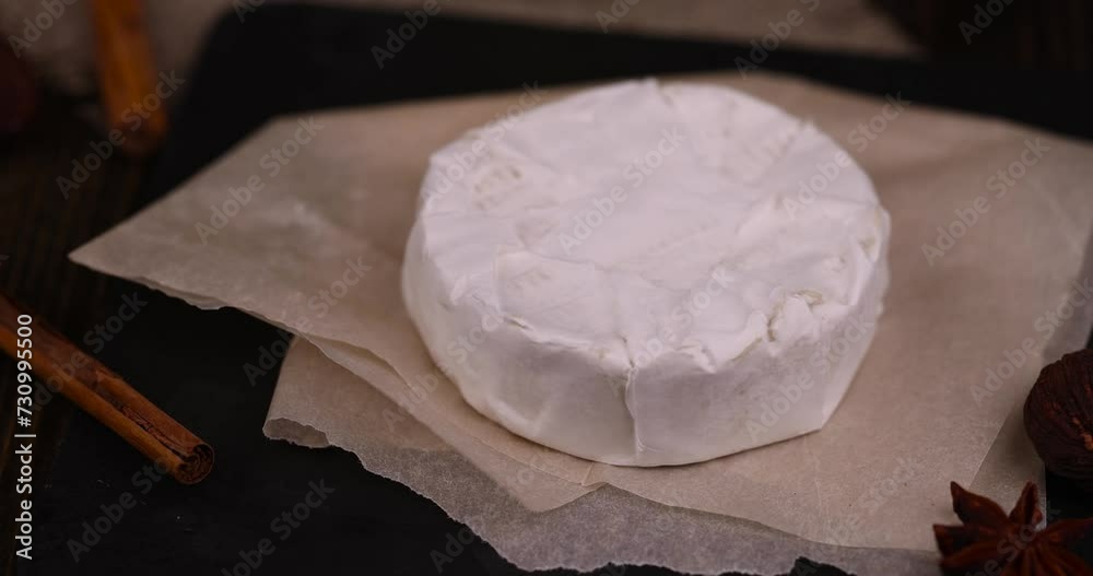 soft processed cheese with white mold on the table, sliced white cheese with mold close-up soft processed cheese with white mold on the table, sliced white cheese with mold close-up