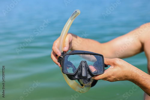 scuba diving mask in the hands of a diver