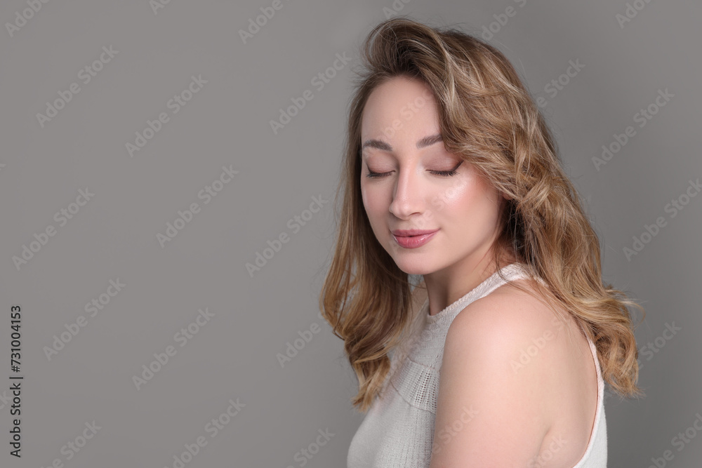 Portrait of beautiful woman on grey background. Space for text Portrait of beautiful woman on grey background. Space for text