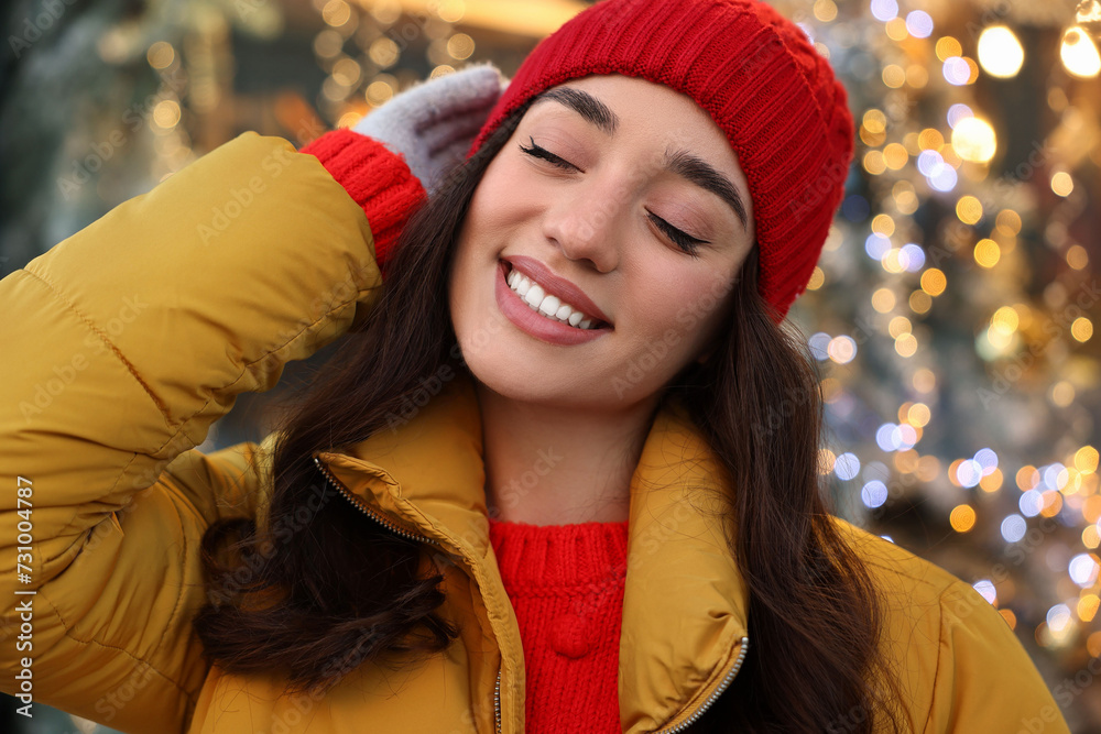 Portrait of smiling woman on blurred background. Winter time Portrait of smiling woman on blurred background. Winter time