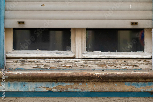 an old wooden window with roller shutters