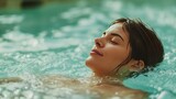 A youthful woman luxuriating in a jacuzzi, indulging in a blissful spa experience
