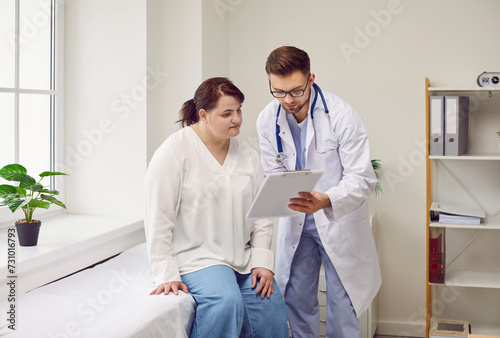 Fotografie Doctor and patient talking about medical examination at clinic