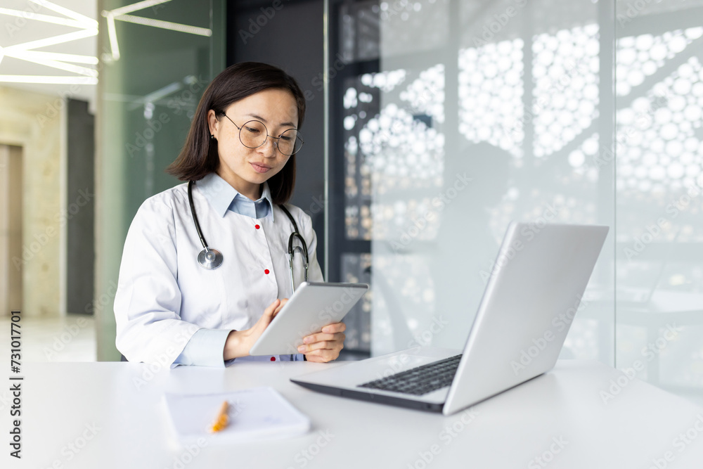 Dedicated Asian doctor in clinic providing online medical consultation and assistance, focused on caring for patients remotely. Dedicated Asian doctor in clinic providing online medical consultation and assistance, focused on caring for patients remotely.