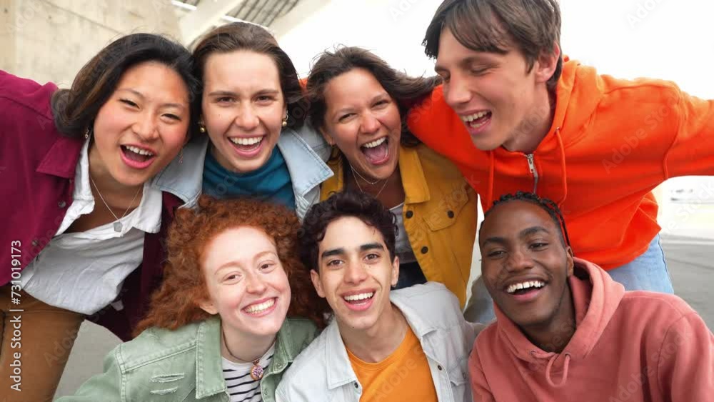 Multi ethnic young people smiling together at camera outdoors - Happy group of friends having fun hanging out in downtown street - University students standing together in college campu Multi ethnic young people smiling together at camera outdoors - Happy group of friends having fun hanging out in downtown street - University students standing together in college campu