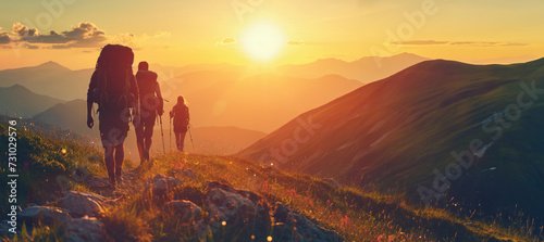 Group of sports tourists hiking in mountains during sunset with copy space