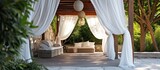 Outdoor terrace with canopy, garden gazebo with flowing white curtains for relaxation, and romantic alcove with baldachin are all wedding decorations.