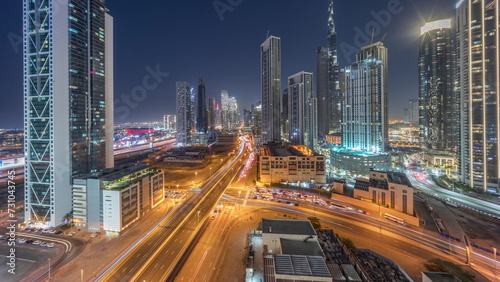 Aerial panoramic view of Dubai Downtown skyline with many towers day to night timelapse.