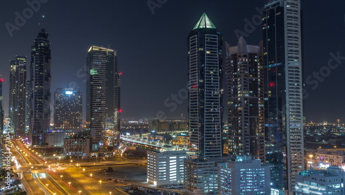 Business bay district skyline with modern architecture all night timelapse from above.