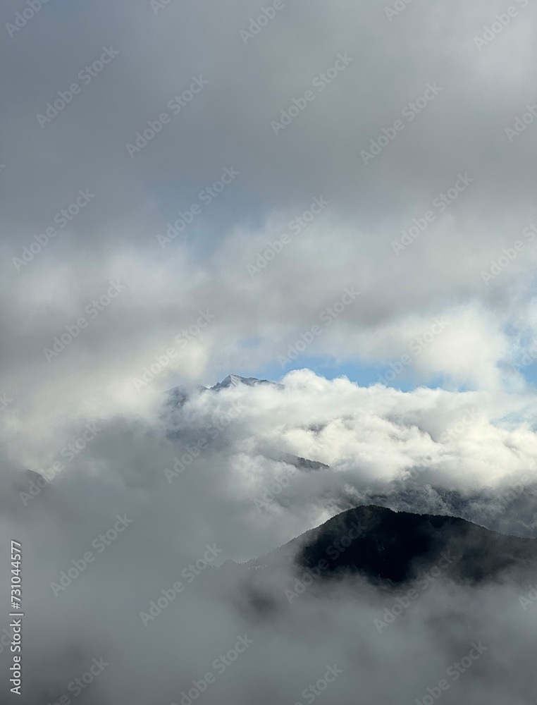 mountain landscape with low clouds and fog