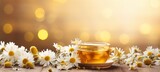 Chamomile tea and daisies on defocused background with space for text, floral composition