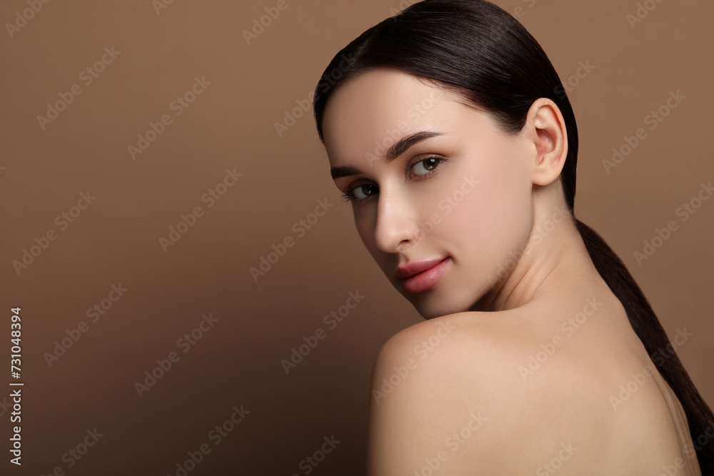 Portrait of beautiful young woman on brown background. Space for text Portrait of beautiful young woman on brown background. Space for text
