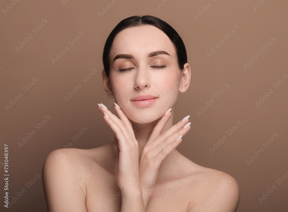 Portrait of beautiful young woman on brown background Portrait of beautiful young woman on brown background