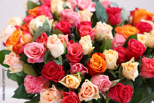 Bouquet of beautiful roses on light grey background, closeup