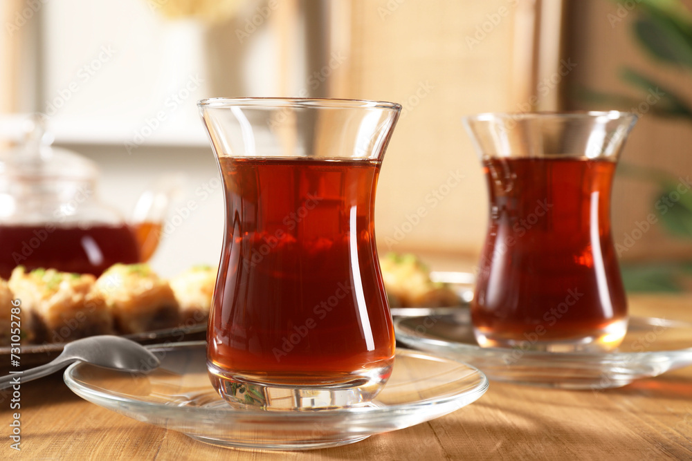 Traditional Turkish tea in glasses on wooden table, closeup Traditional Turkish tea in glasses on wooden table, closeup