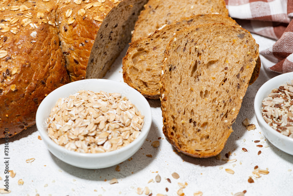 healthy bread with oats and seeds on white background, closeup healthy bread with oats and seeds on white background, closeup