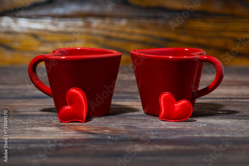 two red cups of tea on wooden background