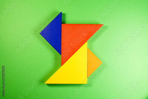 Tangram puzzle on green background using as education and creative concept