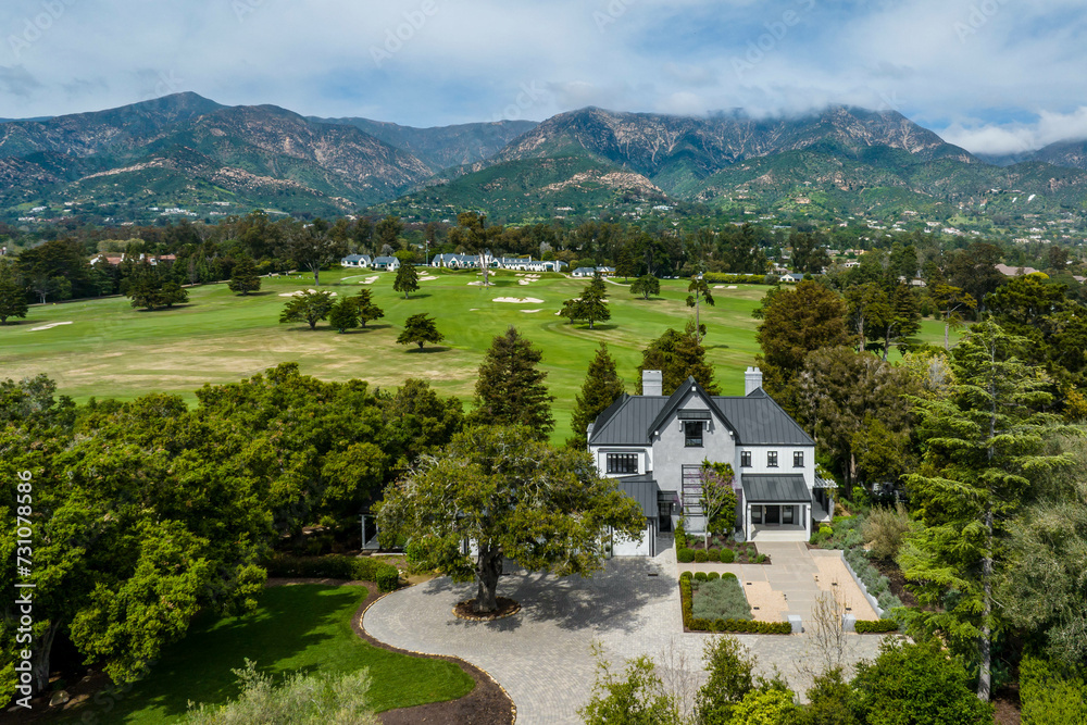 Aerial view of a luxurious mansion nestled on a picturesque golf course