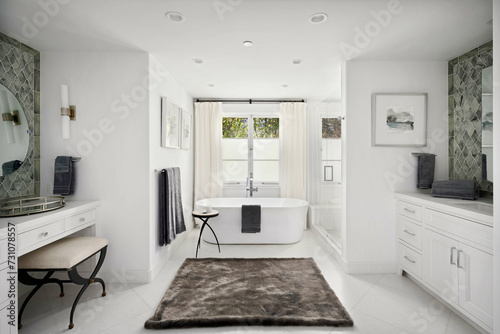 Spacious bathroom featuring a luxurious tub, elegant vanity, and two sinks